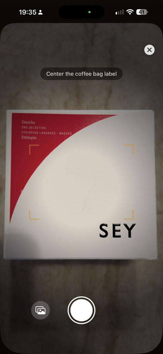 Bean AI camera view scanning a Sey coffee bag label, alignment brackets on the label